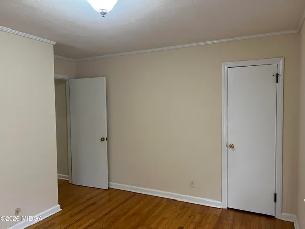 an empty room with wooden floor