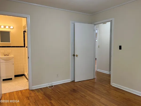 a view of a room with wooden floor