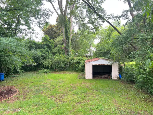 a backyard of a house with a garden and yard