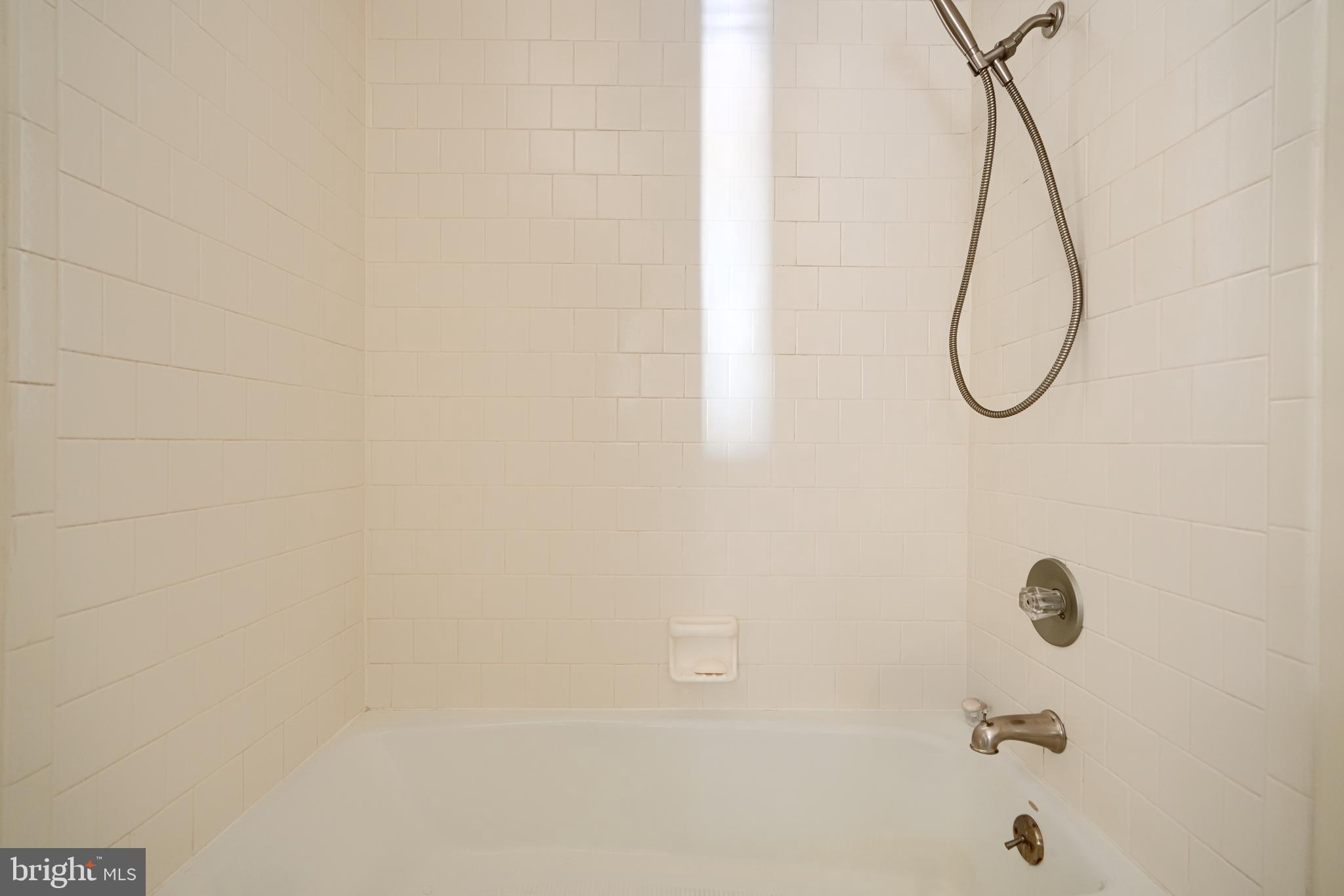 2515 Boston Street, Unit 706 Baltimore, MD 21224 - Photo 11 of 21 a bathroom with a shower