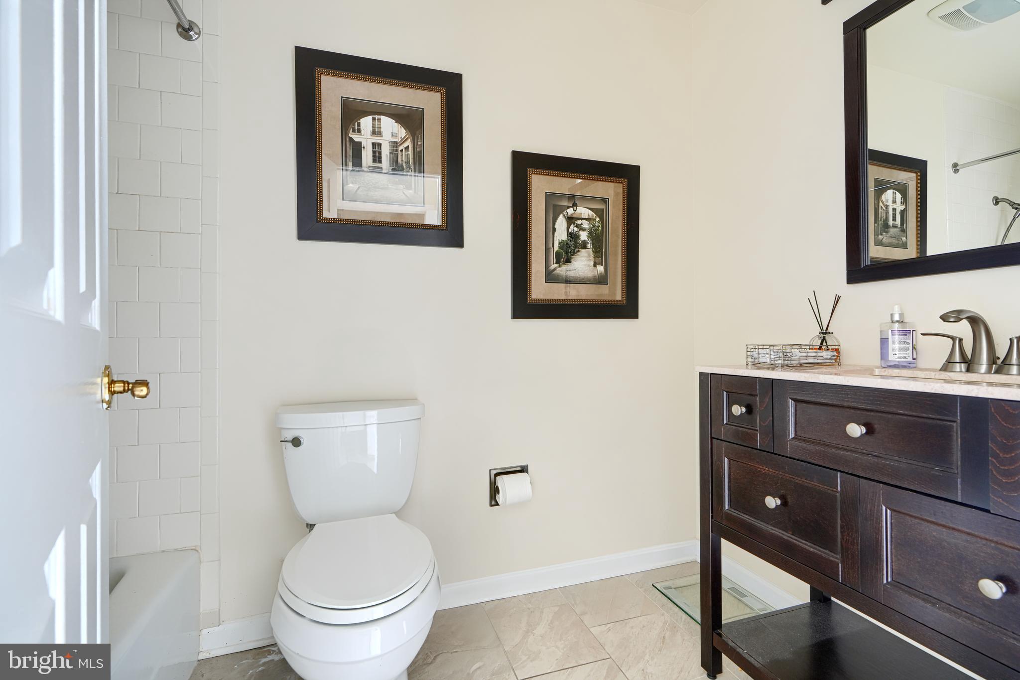 2515 Boston Street, Unit 706 Baltimore, MD 21224 - Photo 12 of 21 a bathroom with a toilet sink and mirror