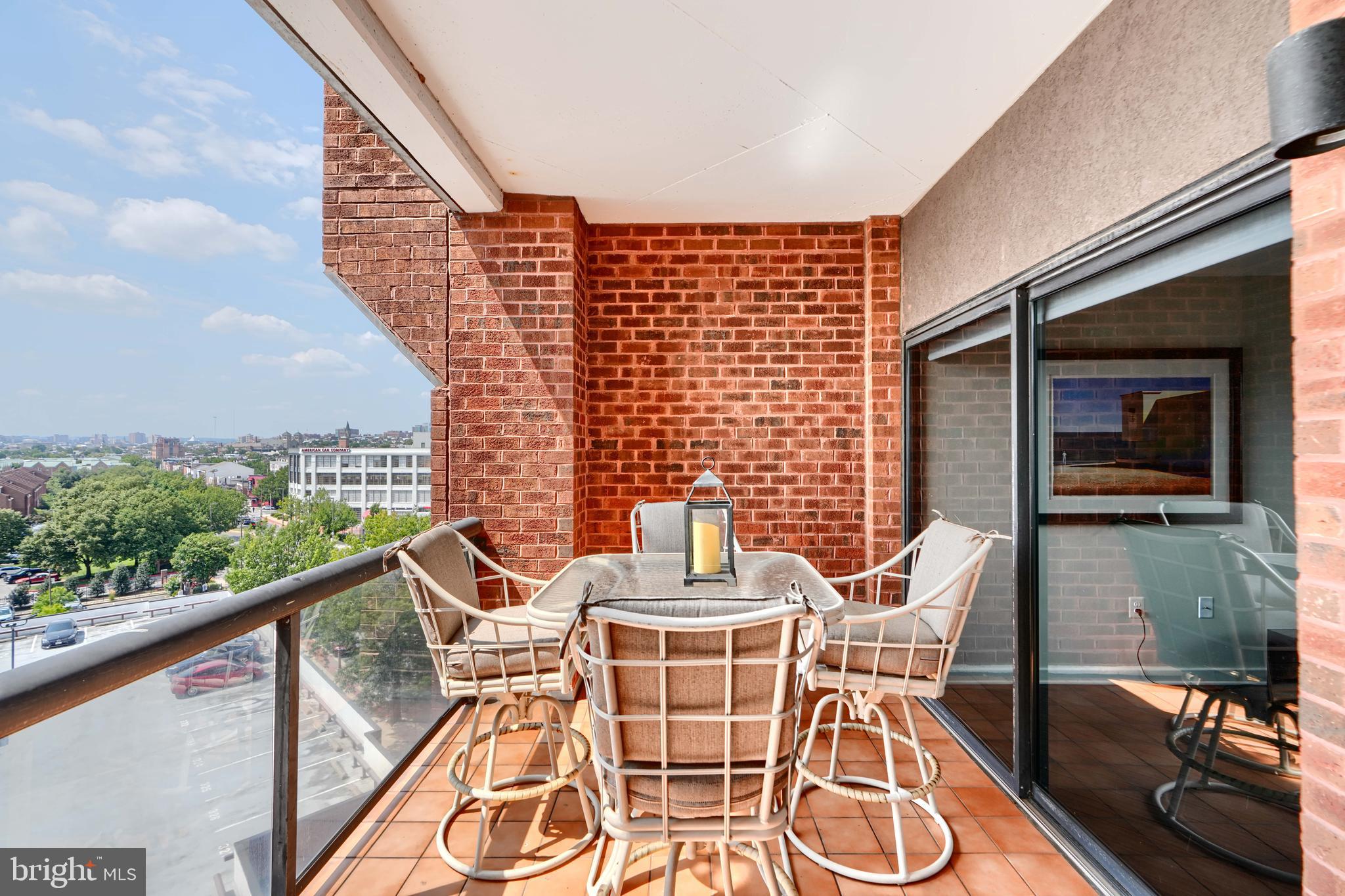 2515 Boston Street, Unit 706 Baltimore, MD 21224 - Photo 14 of 21 a view of a balcony with table and chairs