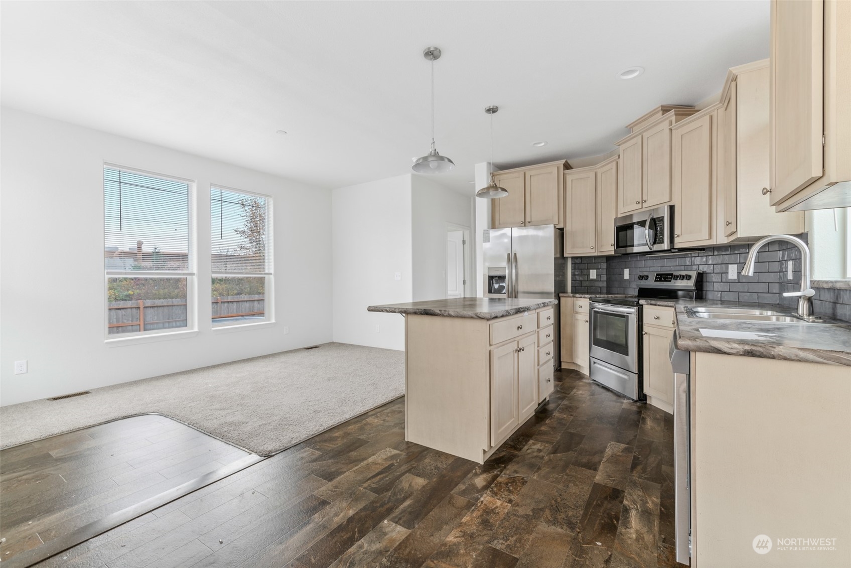 9811 Southwest Herman Road, Unit 45 Tualatin, OR 97062 - Photo 4 of 28 a kitchen with sink a microwave and cabinets