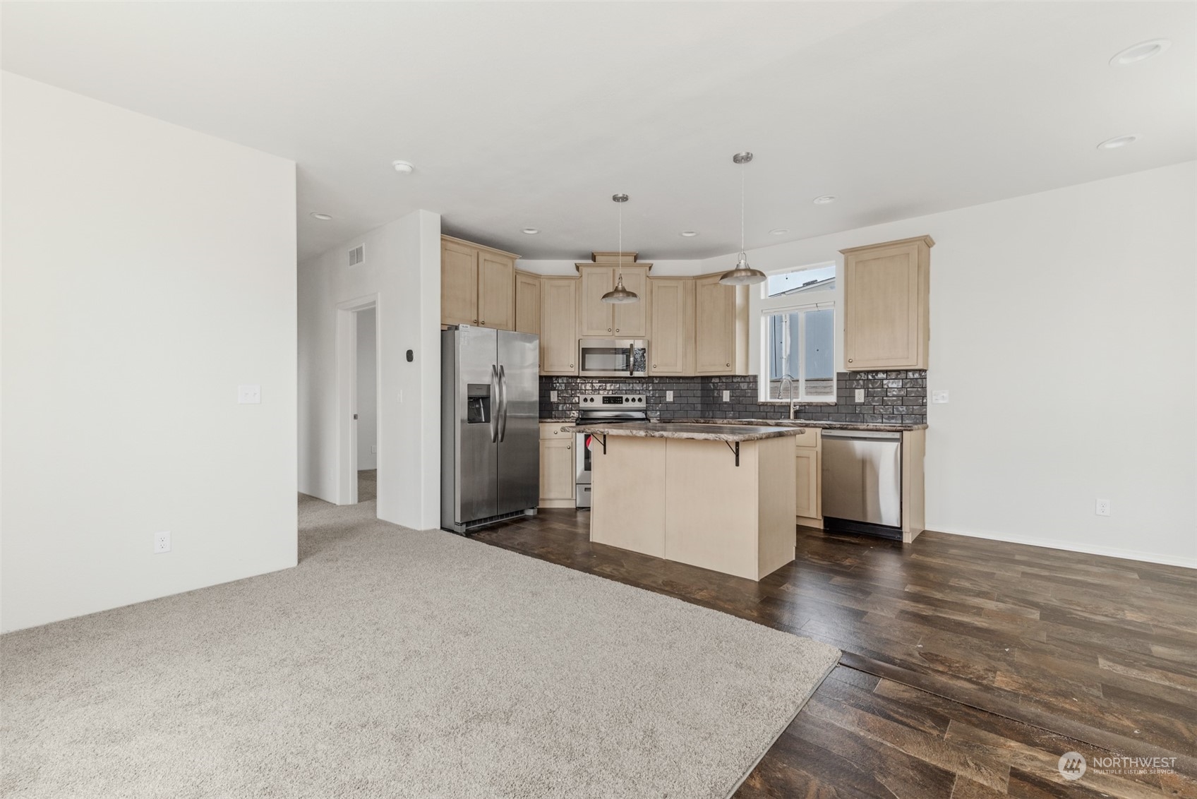 9811 Southwest Herman Road, Unit 45 Tualatin, OR 97062 - Photo 7 of 28 a kitchen with stainless steel appliances granite countertop a refrigerator sink and white cabinets