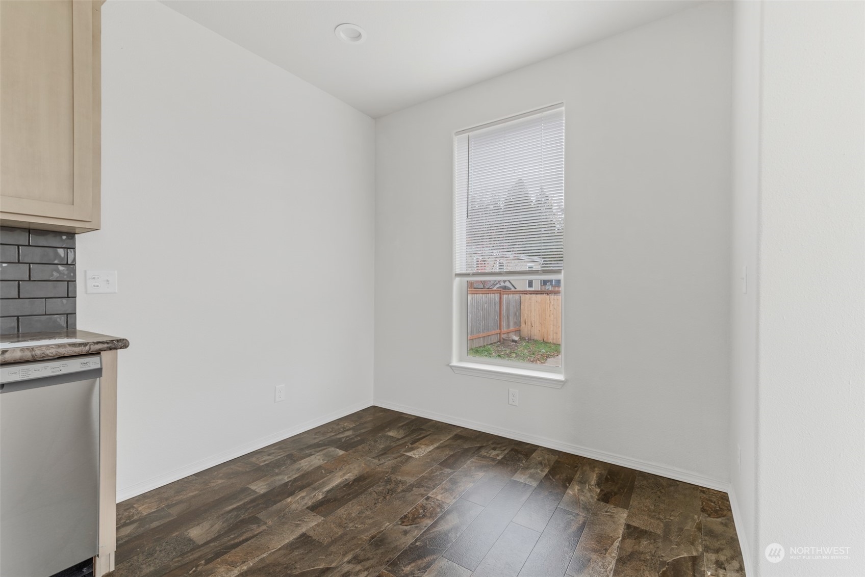 9811 Southwest Herman Road, Unit 45 Tualatin, OR 97062 - Photo 9 of 28 a view of an empty room with wooden floor and a window