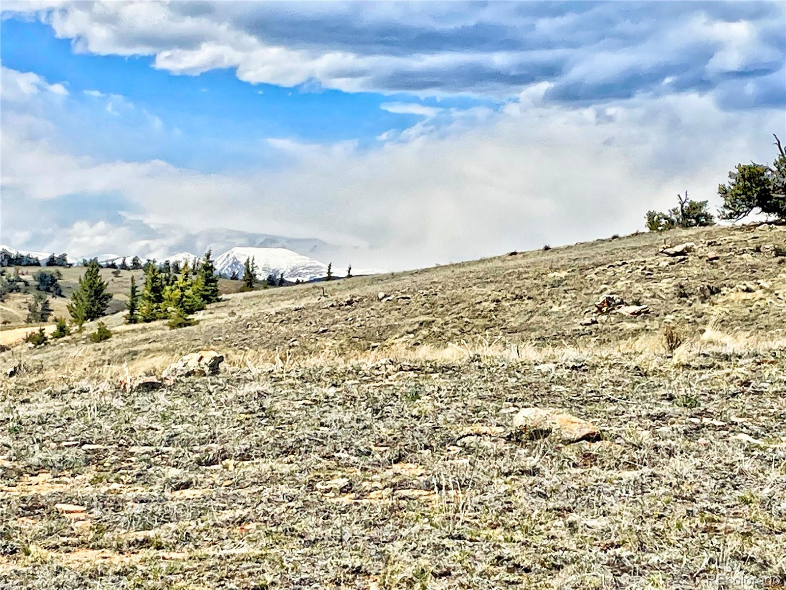 250 Buckhorn Road Como, CO 80456 - Photo 10 of 19 a view of a large building with mountains in the background