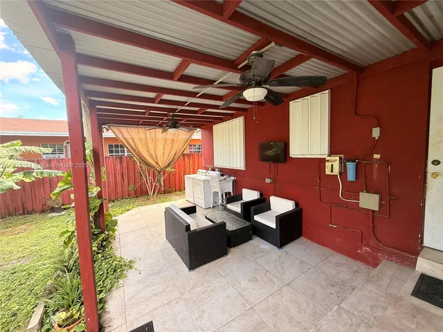 a outdoor space with patio couch and a floor to ceiling window
