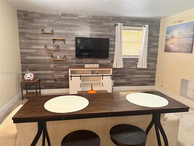a kitchen with a table chairs and a sink