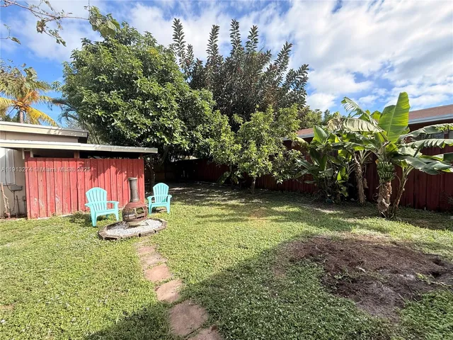 a view of a backyard with sitting area