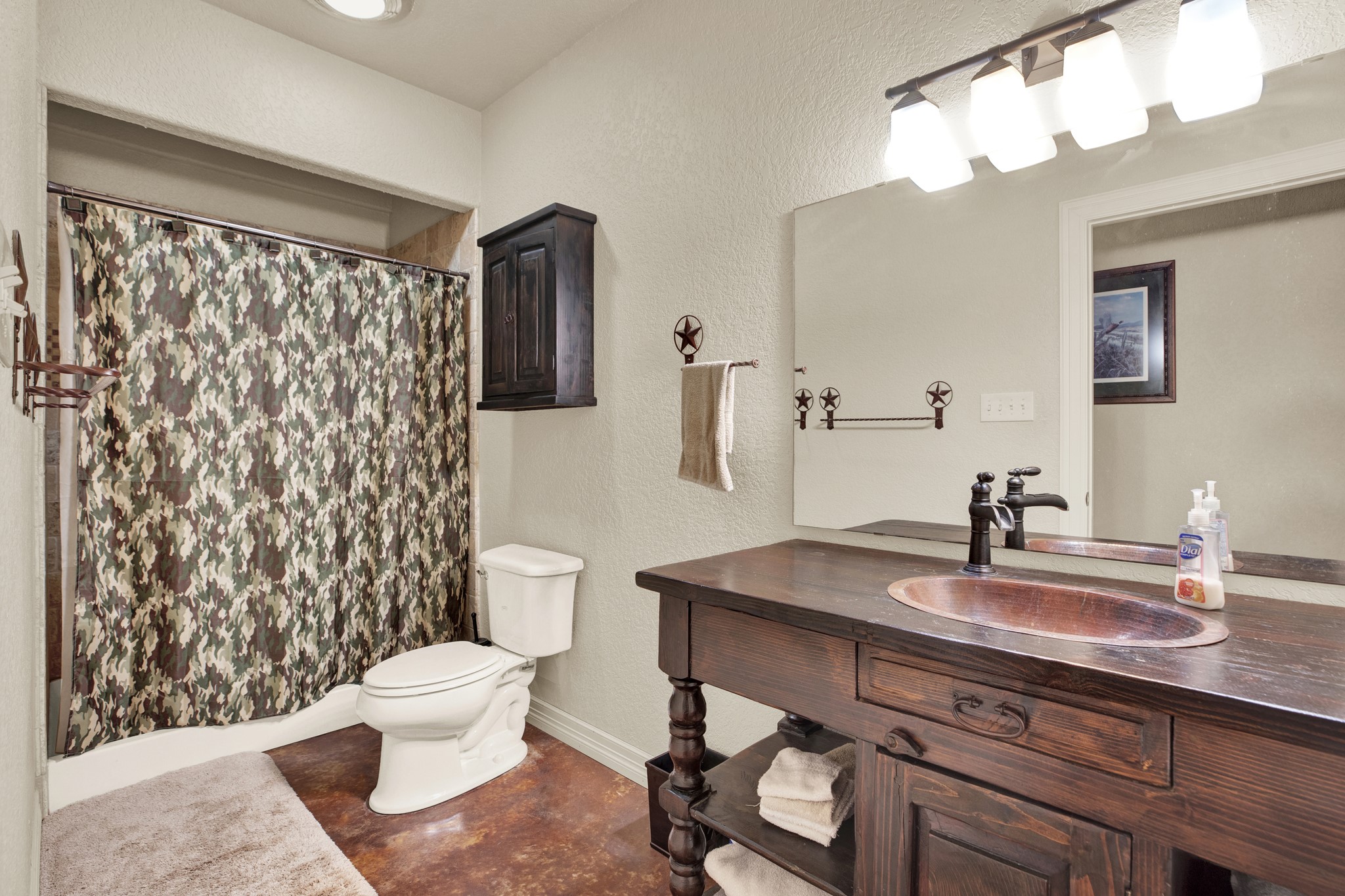 3691 K2 Road Leakey, TX 78873 - Photo 11 of 34 a bathroom with a sink toilet a mirror and shower curtain