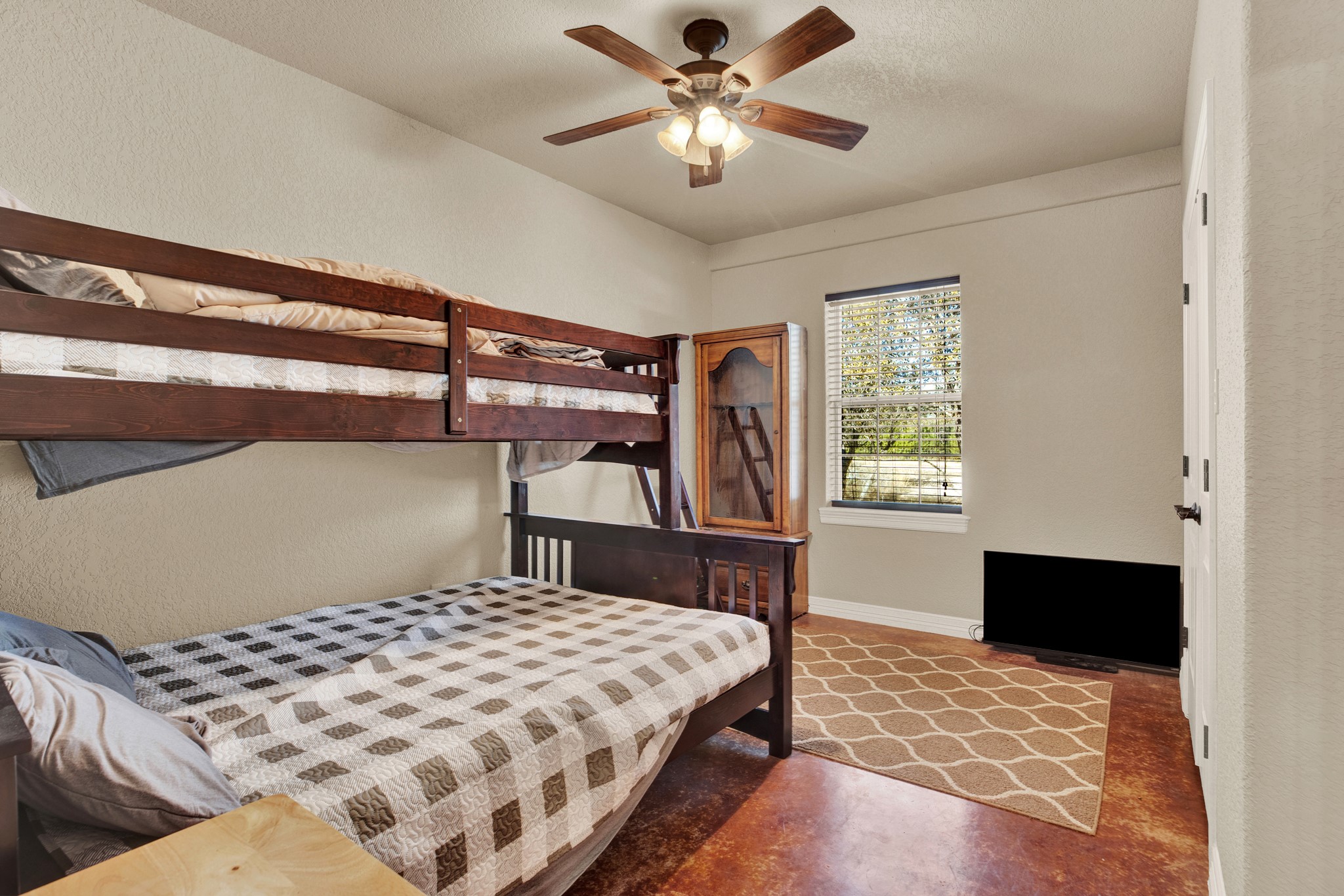 3691 K2 Road Leakey, TX 78873 - Photo 13 of 34 a bedroom with a bed and a chandelier