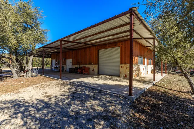 a backyard of a house with oven and a tree