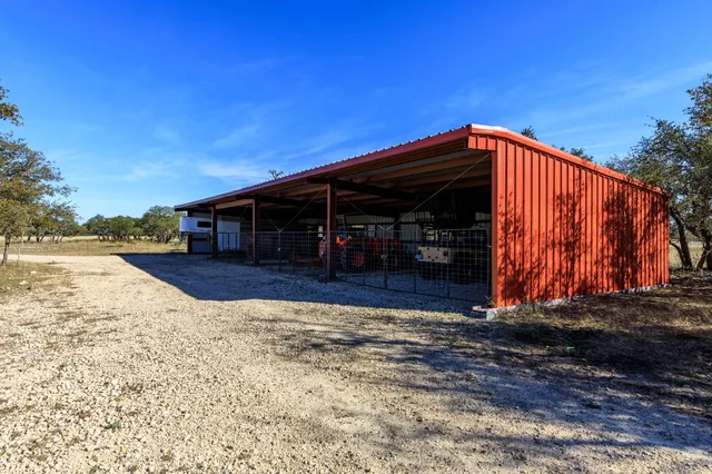 a view of a chairs and table in backyard