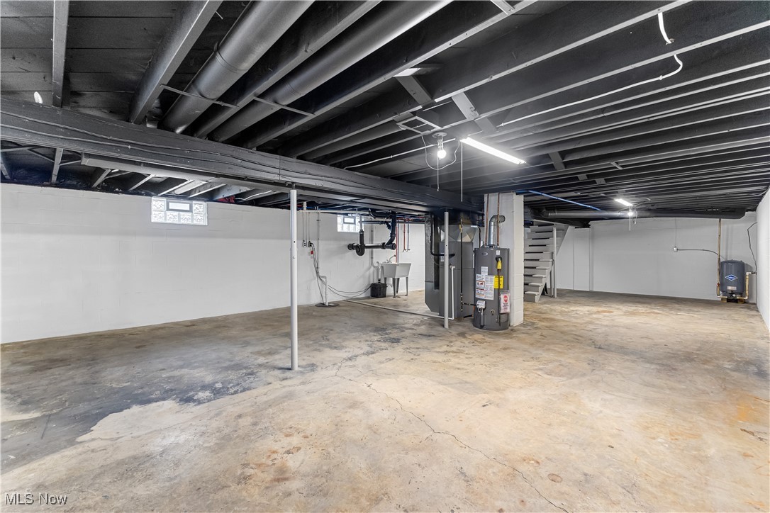 6161 Shaffer Road Northwest Warren, OH 44481 - Photo 19 of 20 Basement featuring heating unit, sink, and water heater