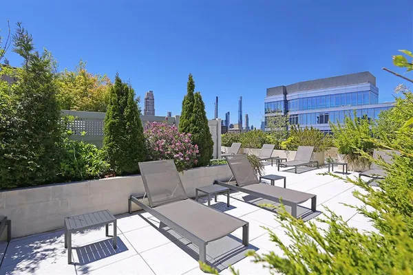 a view of a patio with couches table and chairs and potted plants