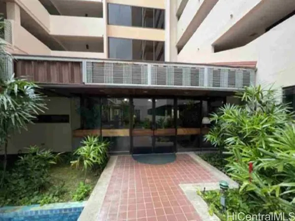 a view of a house with plants and sitting area