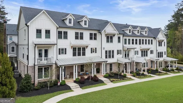 a view of an apartment with a garden and patio