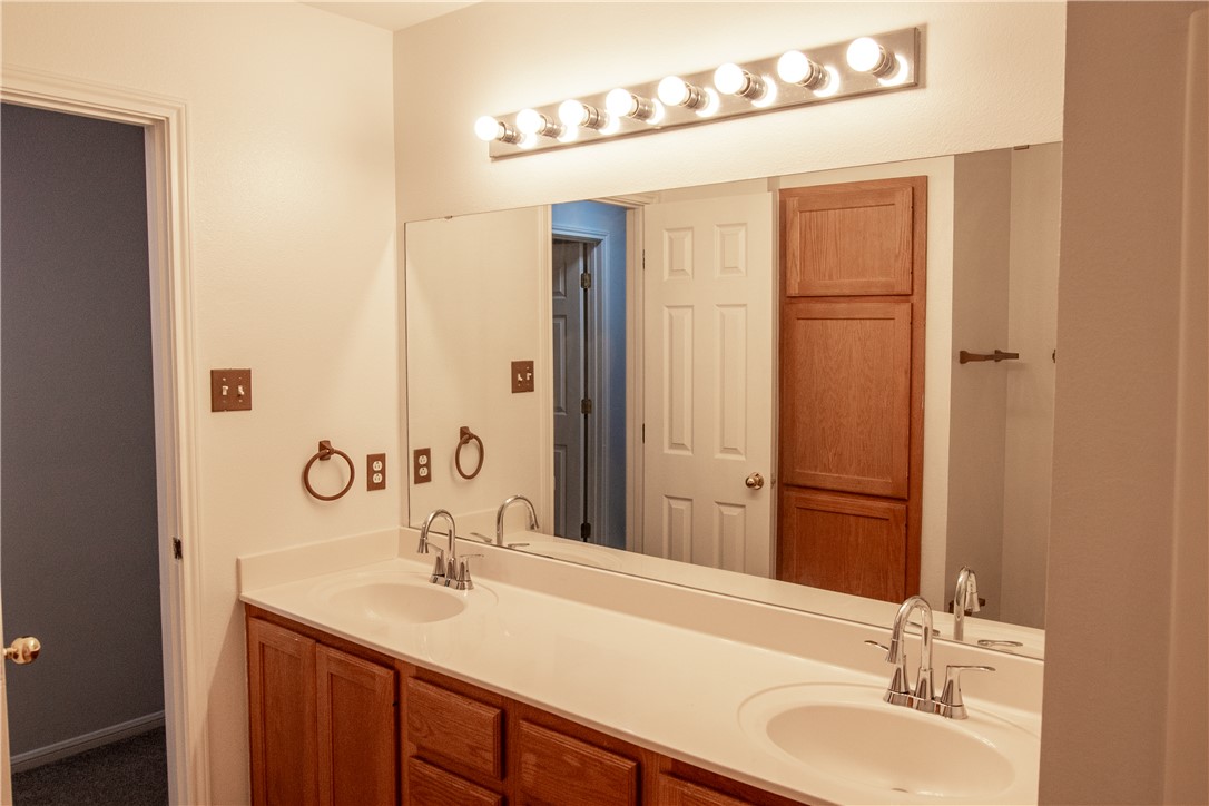 1735 Rock Hollow Loop Bryan, TX 77807 - Photo 14 of 25 a bathroom with a granite countertop sink and a mirror