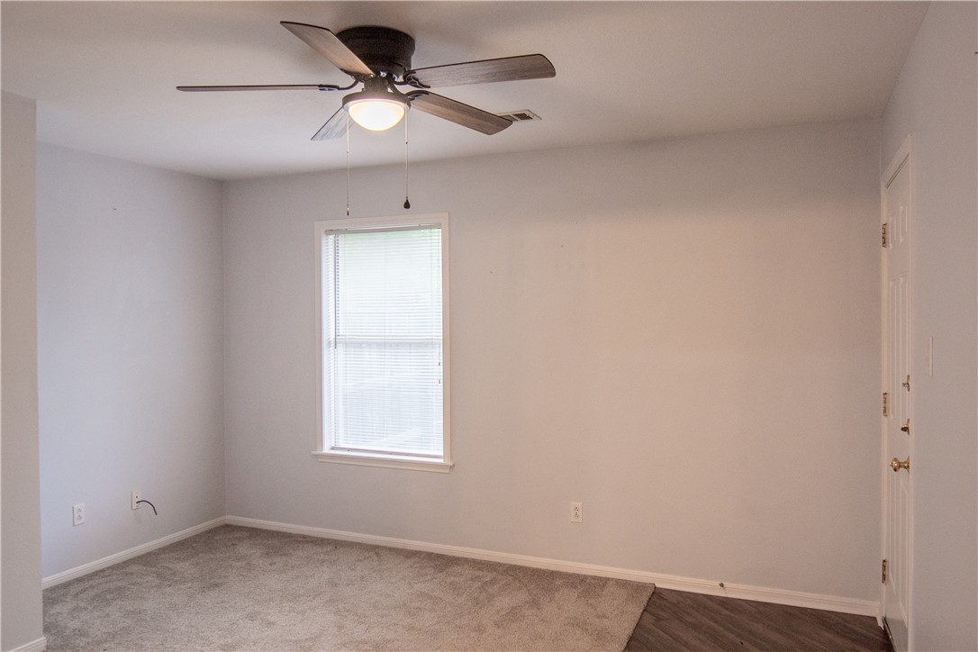 1735 Rock Hollow Loop Bryan, TX 77807 - Photo 19 of 25 an empty room with a window and a fan