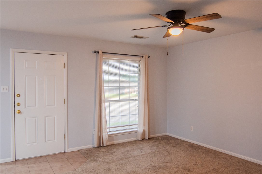 1735 Rock Hollow Loop Bryan, TX 77807 - Photo 9 of 25 an empty room with fan and windows