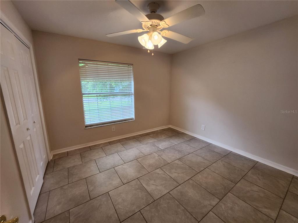 6521 East Grayson Street Inverness, FL 34452 - Photo 15 of 16 an empty room with windows and fan