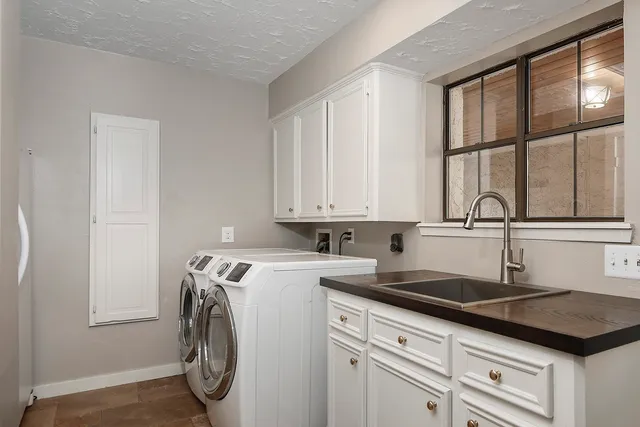 a kitchen with a sink a stove and cabinets