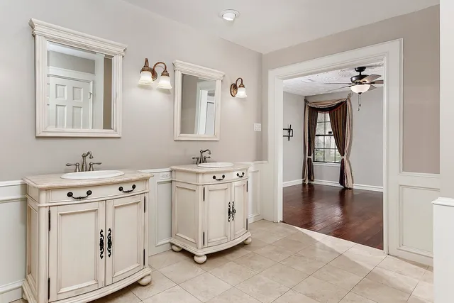 a spacious bathroom with a double vanity sink and a mirror