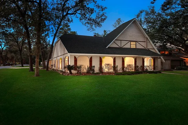 a aerial view of a house next to a yard