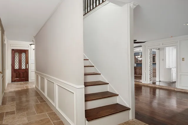 a view of entryway and hall with wooden floor