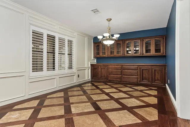 a view of a livingroom with a dinning area wooden floor and a window