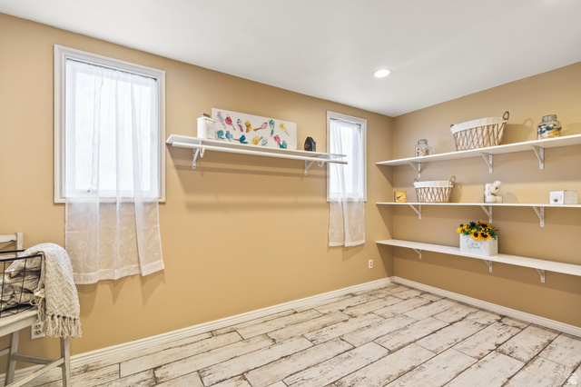 460 Omni Point Road Central Valley, UT 84754 - Photo 56 of 101 Room featuring extensive wall-mounted shelving, two windows, recessed ceiling lighting, and wood-finish flooring