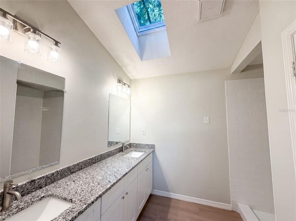 3739 Lake Griffin Road Lady Lake, FL 32159 - Photo 14 of 21 a bathroom with a granite countertop sink and a mirror