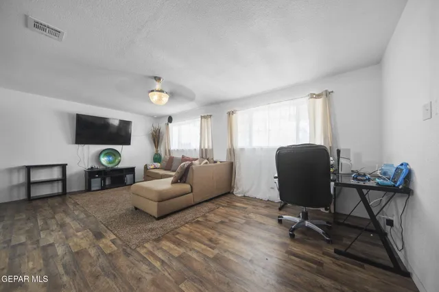 a living room with furniture rug and a window