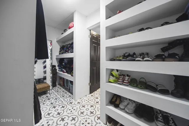 a kitchen with white cabinets and appliances