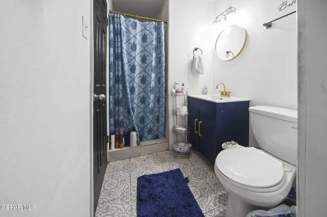 a bathroom with a toilet a sink and a mirror