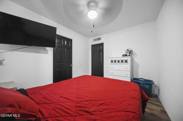 a bed room with a bed and a television