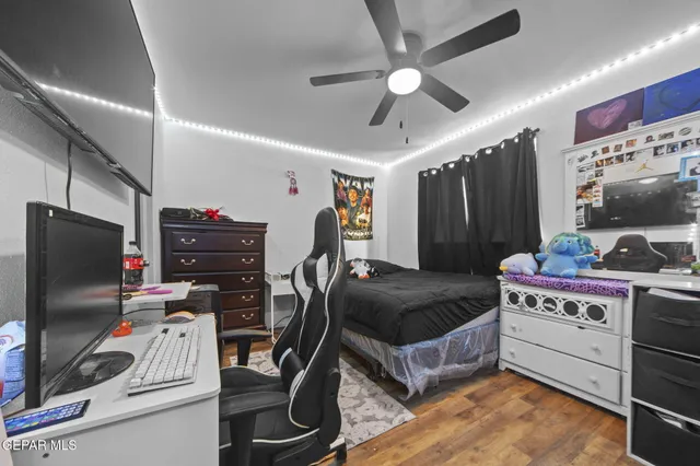 a bedroom with furniture and a flat screen tv