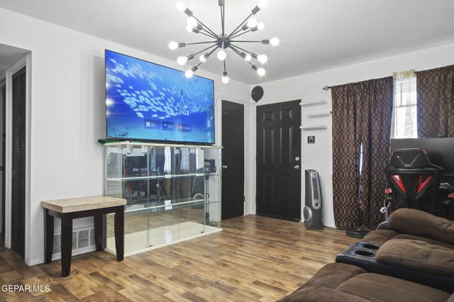 a living room with furniture and a flat screen tv