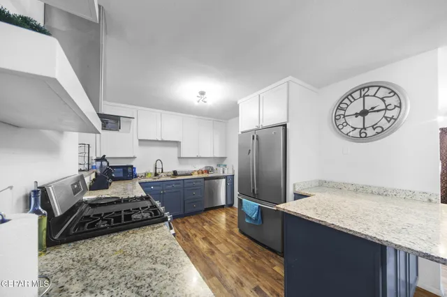 a kitchen with refrigerator and stove