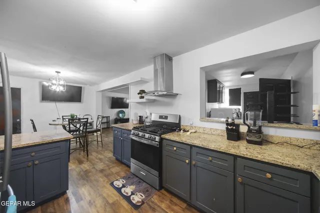 a kitchen with sink stove and cabinets