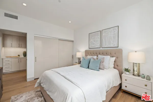 a bedroom with a bed and a lamp