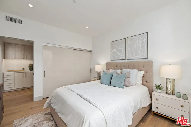 a bedroom with a bed and a lamp