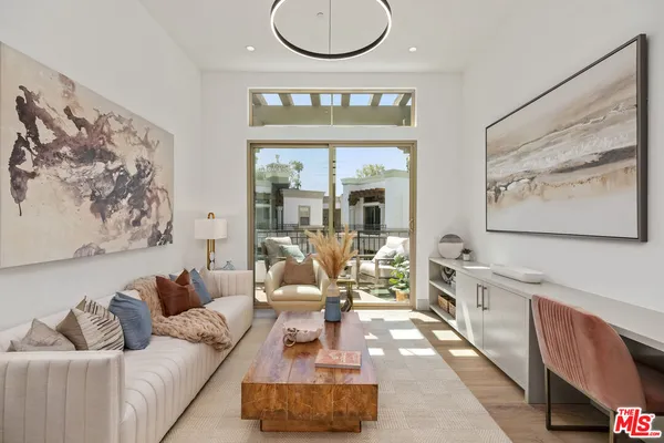 a living room with furniture and a floor to ceiling window