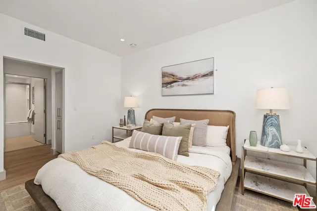 a bedroom with bed and cupboard