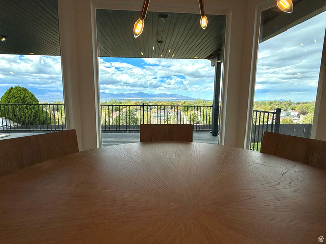 10158 High Point Lane Sandy, UT 84092 - Photo 24 of 24 Expansive windows, black metal balcony railing, and a distant mountain range