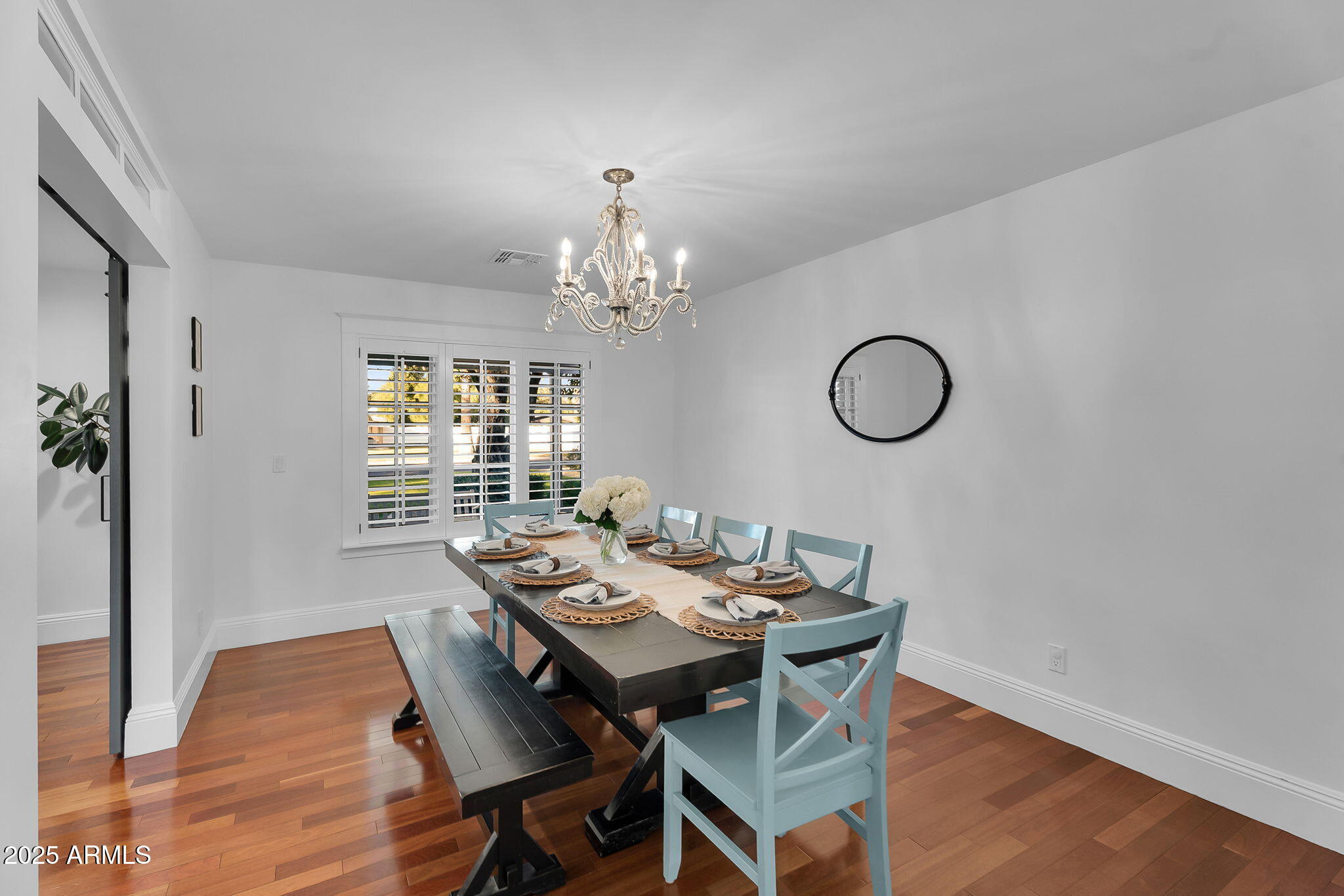 229 West Berridge Lane Phoenix, AZ 85013 - Photo 17 of 78 a view of a dining room with furniture wooden floor and chandelier