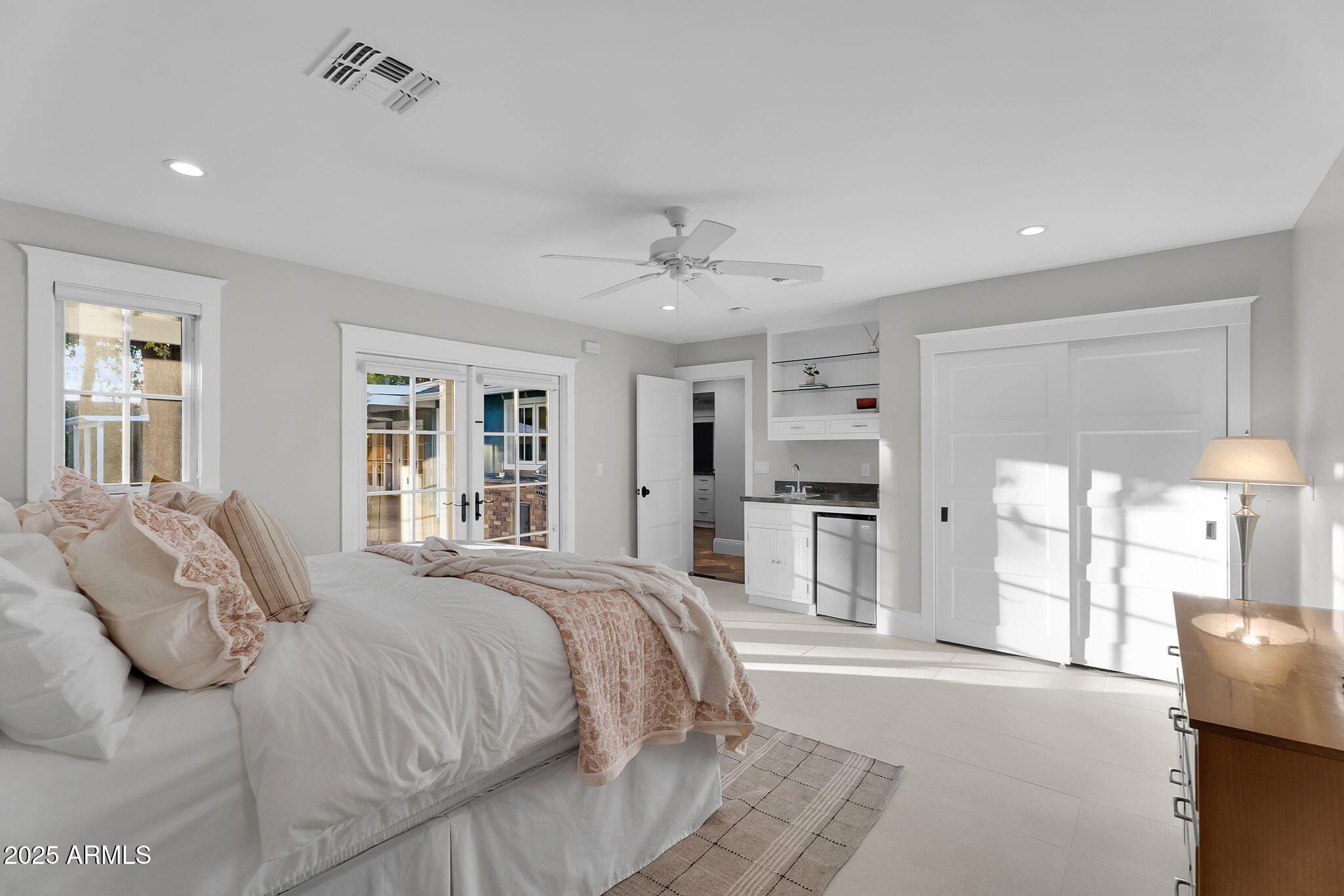 229 West Berridge Lane Phoenix, AZ 85013 - Photo 47 of 78 a spacious bedroom with a large bed and a chandelier