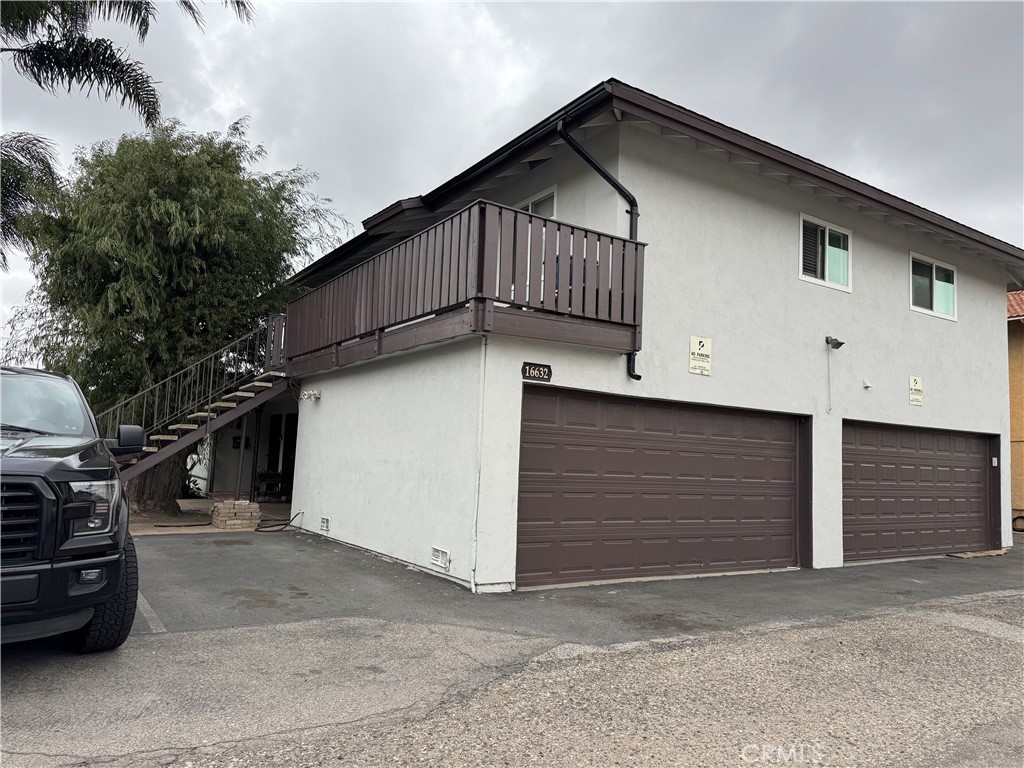 16632 Goldenwest Street, Unit 4 Huntington Beach, CA 92647 - Photo 1 of 1 a front view of a house with garage