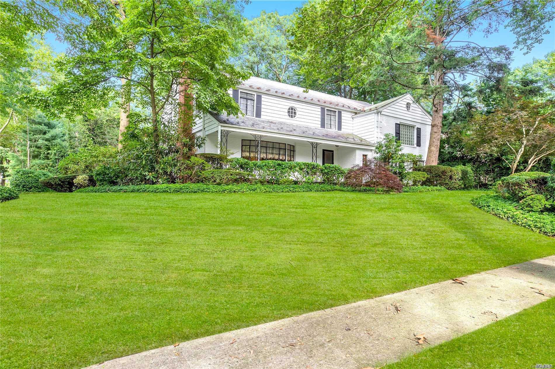 1 Hampton Road Great Neck, NY 11020 - Photo 1 of 1 a front view of a house with a garden