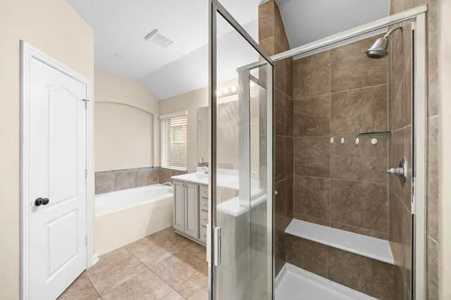 a bathroom with a bathtub and a shower